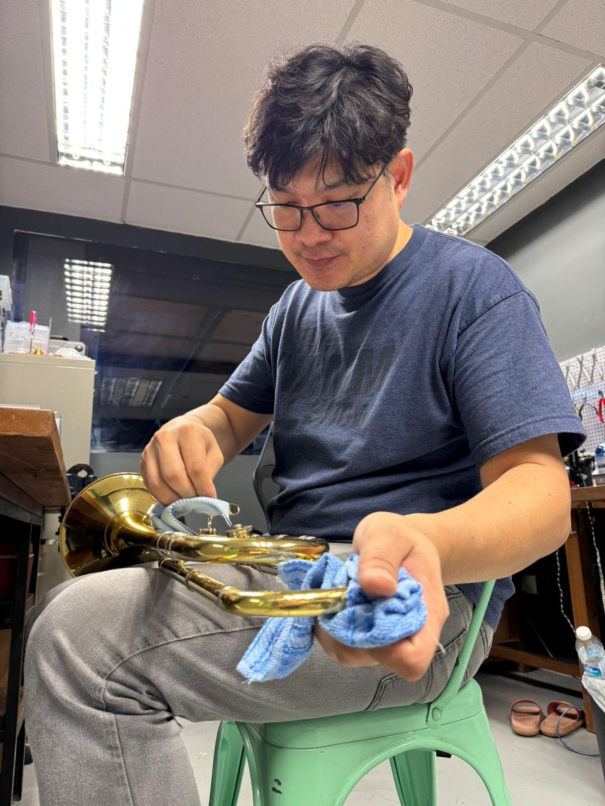 Polishing a trumpet at the repair bench