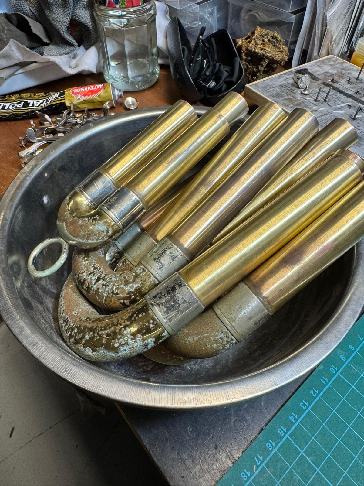 Corroded brass tuning slides awaiting restoration