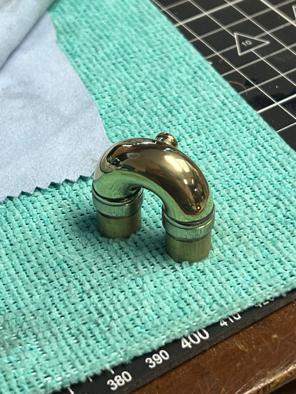 A freshly polished brass neck, ready for reassembly