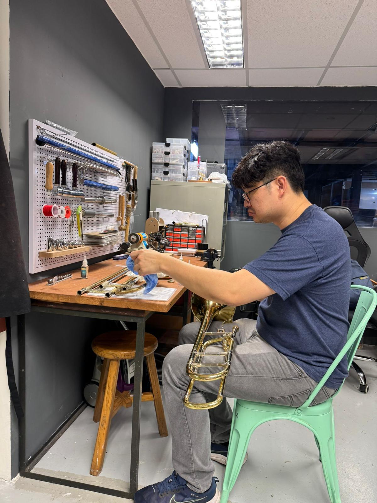 Cleaning trombone slides at the workbench